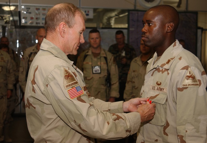 Warrant Officer One Donnell McIntosh receives the Bronze Star medal with Valor device from 1st Armored Division commander Major General Martin Dempsey (later Chief of Staff of the Army and Chairman of the Joint Chiefs of Staff). (Credit: JAG Corps Regimental Archives)